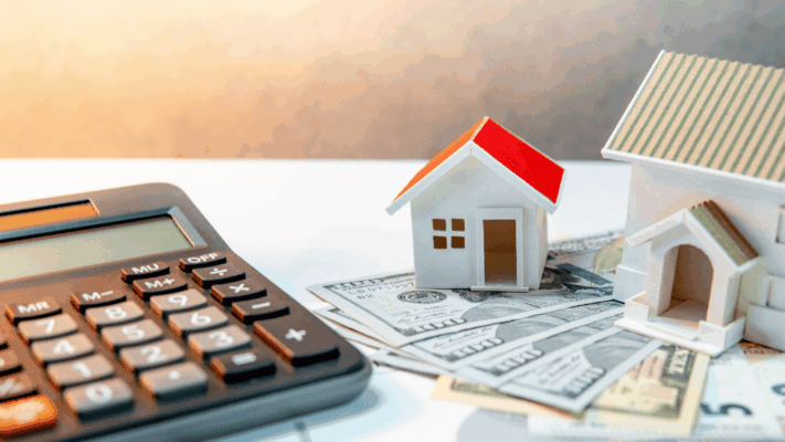 Calculator beside miniature house models placed on U.S. dollar bills, representing common real estate investing mistakes, property investment planning, housing market analysis, mortgage calculations, financial decision-making, real estate budgeting, beginner investor challenges, property financing strategies, investment risk management, and wealth-building through real estate.
