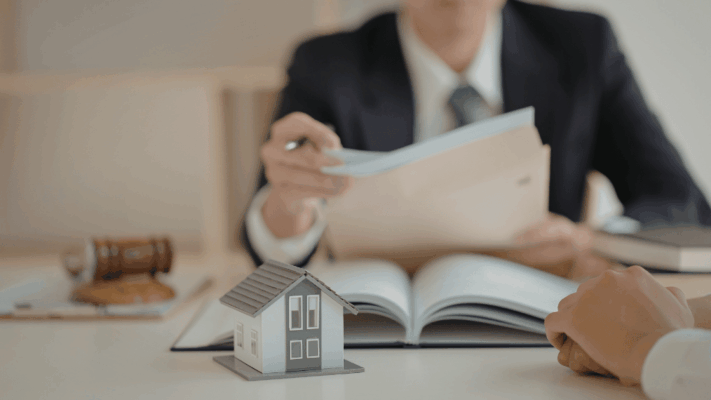 Real estate professional reviewing investment documents with a client during a syndication property listing consultation meeting
