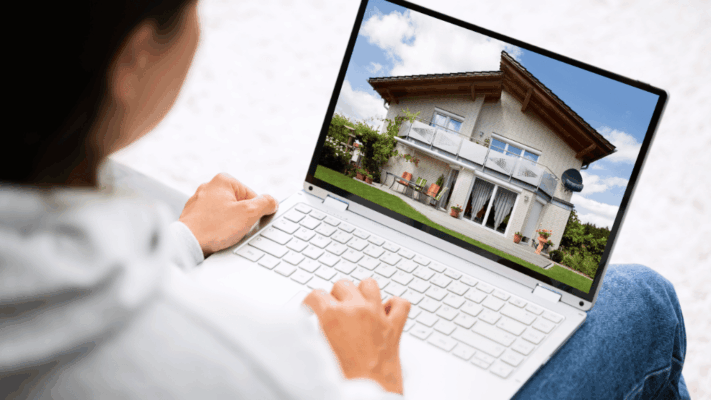 Person viewing a residential property listing online on a laptop during real estate investment and property management research
