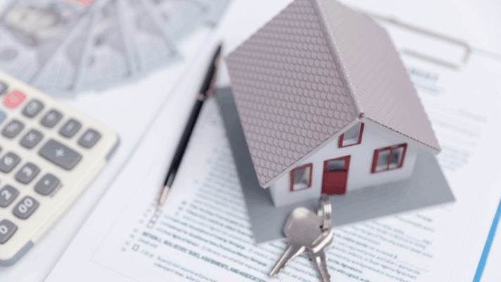 Miniature house model with keys placed on financial paperwork beside a calculator and pen, representing portfolio rebalancing strategies, real estate investment management, property asset allocation, housing finance planning, mortgage evaluation, investment diversification, real estate portfolio optimization, financial analysis, property ownership planning, and long-term wealth management for real estate investors.

