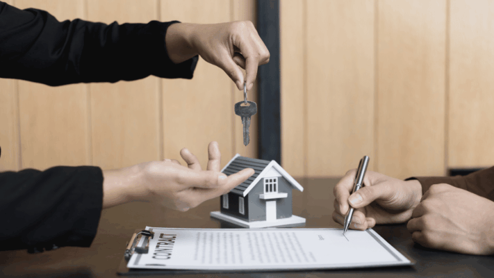 A real estate transaction scene showing a buyer signing documents while receiving a property key beside a model home, symbolizing a carefully selected investment opportunity. The image represents multifamily property acquisition, investment due diligence, commercial real estate transactions, property evaluation, disciplined underwriting, acquisition strategy, investor confidence, deal selection, contract execution, and the key factors that make a strong multifamily acquisition opportunity.
